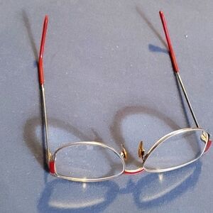 Vintage eye glasses. Metal with red trim. Good used condition.